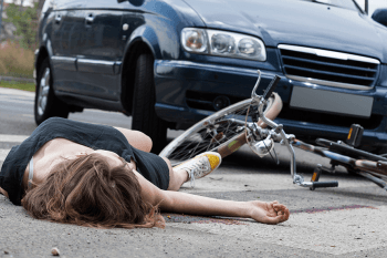 bike rider hit by car on the ground